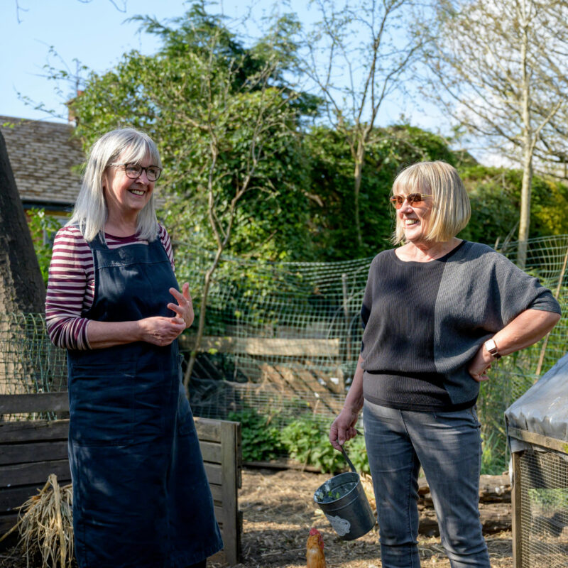Two ladies having a light hearted conversation